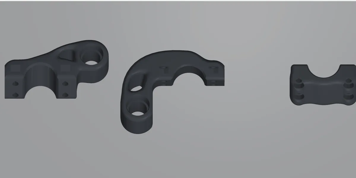 The v9 clamp bodies and cap laid out as printed